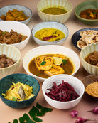 assortment of sri lankan curries in bowls 
