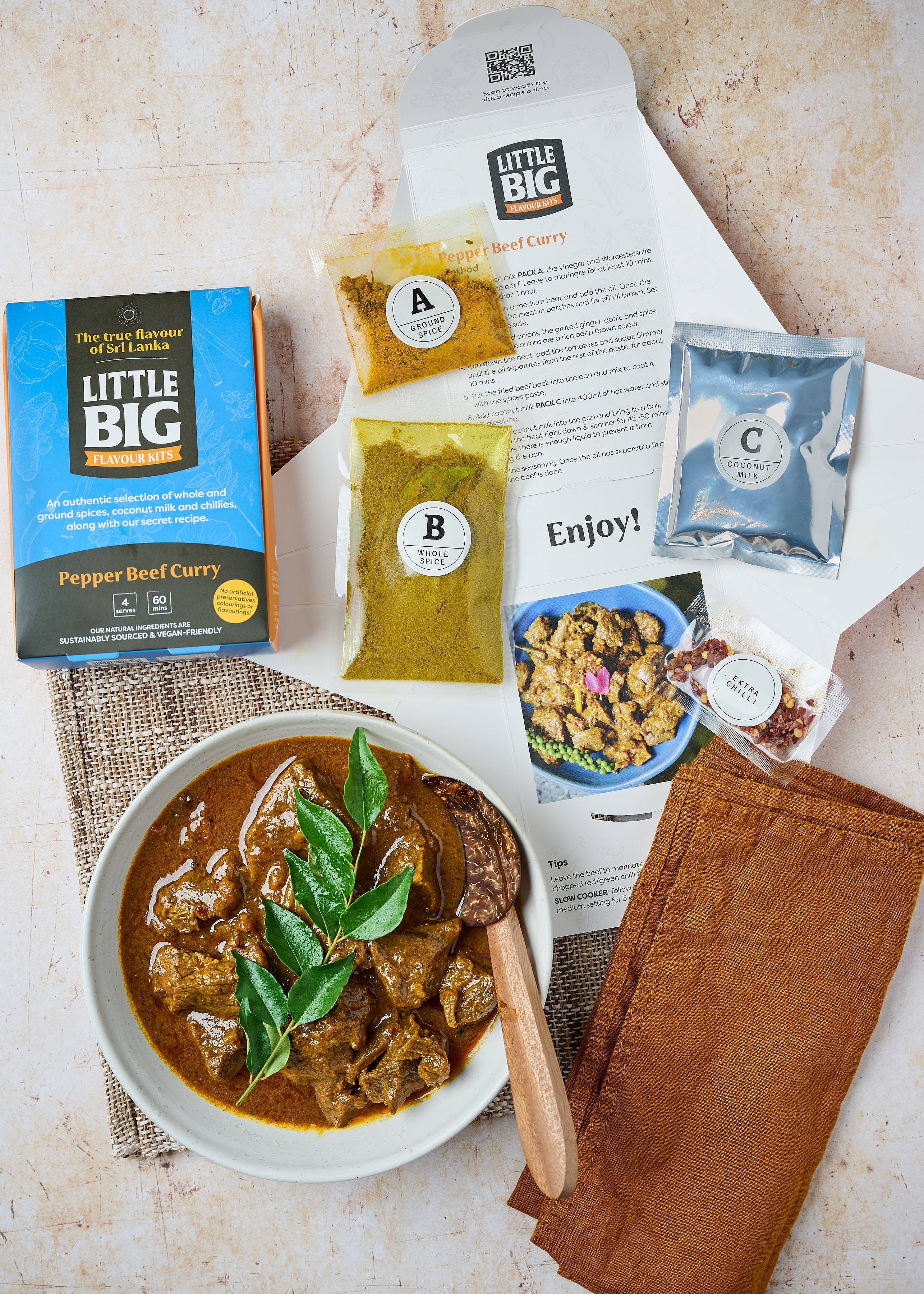 open pack of LIttle big flavour kits pepper beef curry kit with finished curry and spices and coocnnut milk and extra chilli pack inside. 